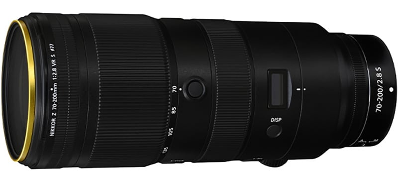 A black Nikon telephoto zoom lens with focal lengths ranging from 70-200mm. The lens features a display and control buttons, and has a gold accent near the front element. Model markings are visible on the side.