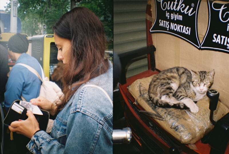 A woman with long brown hair checks her phone while standing in a crowd, holding a black bag. Beside her, a striped cat with white paws rests on a cushion under signs with Turkish text.