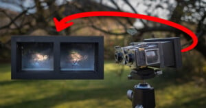 A vintage camera mounted on a tripod outdoors points towards an inset image showing two foggy rectangular windows with light shining through. A red arrow connects the camera to the inset image, indicating a relationship.