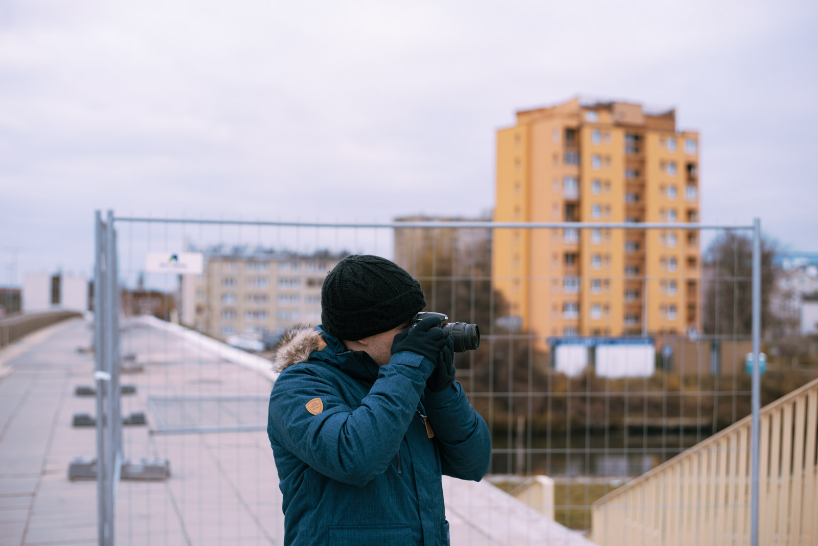 A young man using Nikon D3200 for street photography