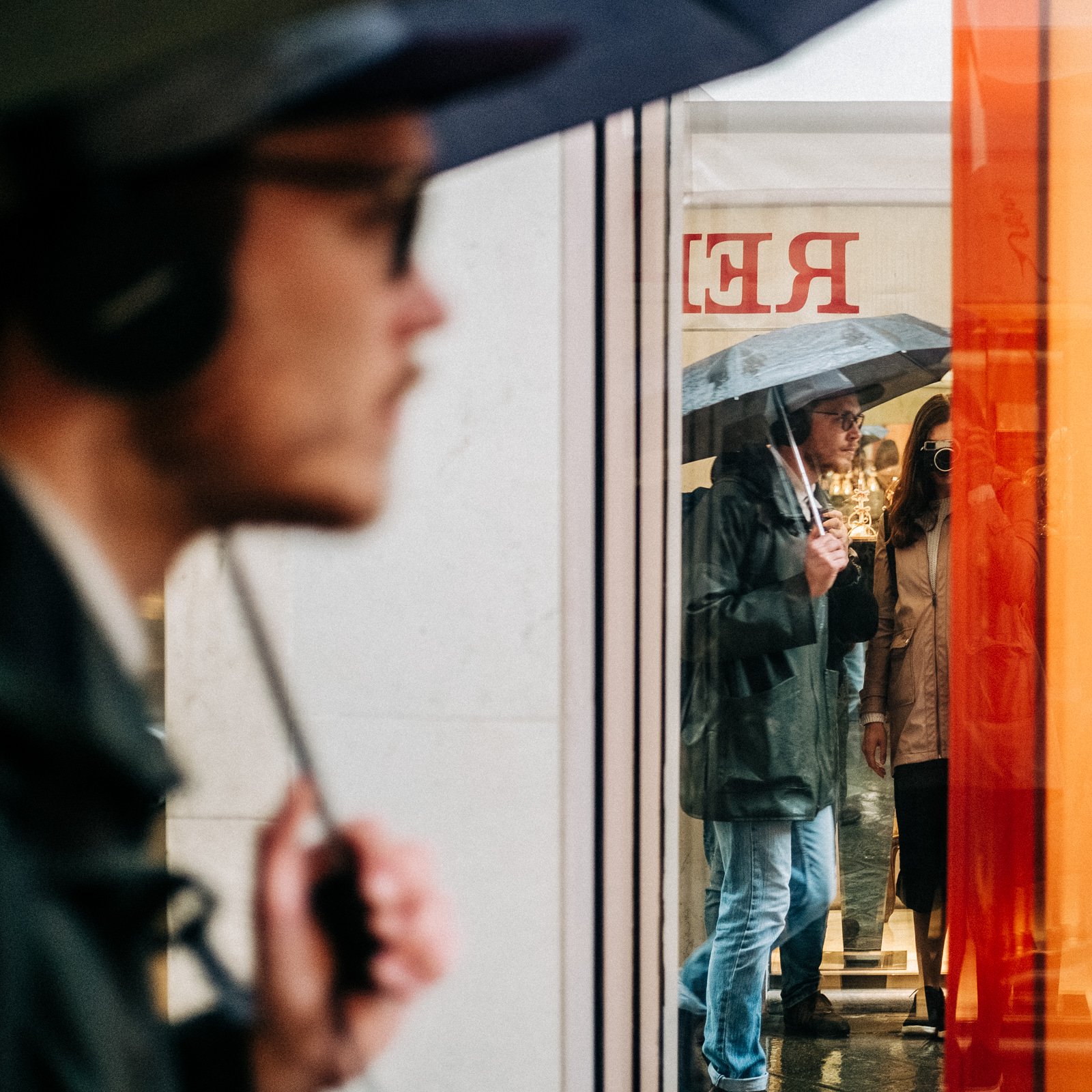 A man with an umbrella walking in Venice