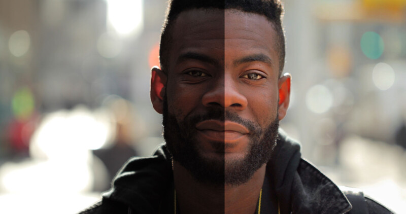 A man's face is shown in close-up with a split down the middle; the left side is bright with high contrast, while the right side is darker with lower contrast. The background is a blurred cityscape with bokeh lights.