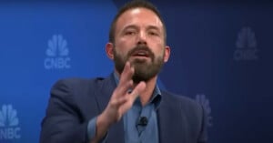 A man with a beard is speaking passionately, gesturing with his hand. He is wearing a blue blazer and shirt, sitting in front of a backdrop with the CNBC logo.