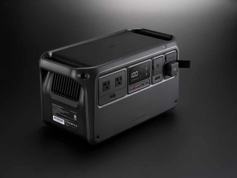 A sleek, rectangular portable power station with multiple outlets and a digital display on a dark background. The design is compact and modern, featuring USB ports, AC sockets, and a ventilation grill.