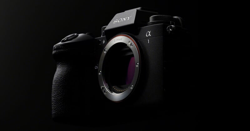 A Sony Alpha mirrorless camera is displayed against a dark background. The camera's body, with its lens mount visible, is highlighted, showcasing its sleek design and textured grip.