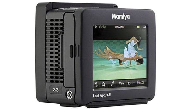 A digital camera back with a screen displaying a gymnastics scene, featuring two athletes performing handstands. The device is labeled "Mamiya Leaf Aptus-II 33.