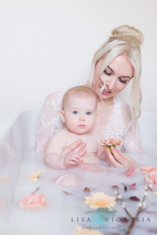 A woman with her baby in a milk bath