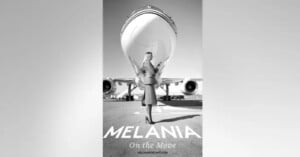 A woman stands confidently under the nose of a large airplane, wearing a coat and heels. The black and white image reads "MELANIA: On the Move" at the bottom, with the website "MELANIATRUMP.COM" beneath.