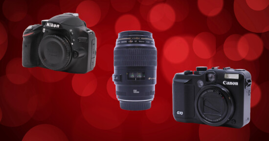 Three camera items against a red bokeh background: a Nikon DSLR body on the left, a Canon camera lens in the center, and a Canon G10 compact camera on the right.