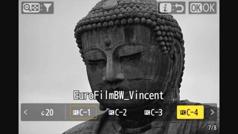 Close-up of a large Buddha statue in black and white, taken through a camera viewfinder. Various camera settings and options, such as "C-4" and "FC-1," are visible, along with text that reads "EuroFil mBW_Vincent.