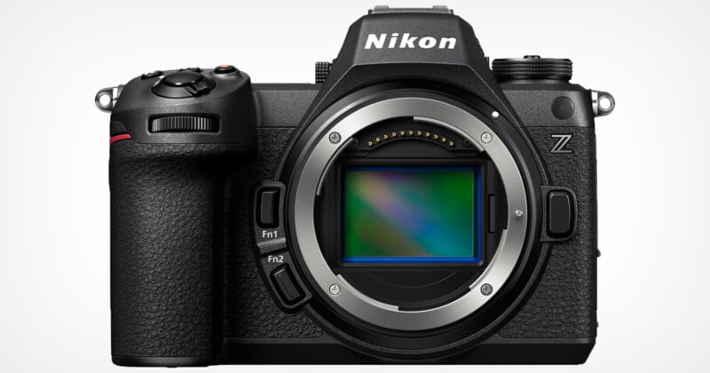 A Nikon Z-series mirrorless camera facing forward, displaying its lens mount and sensor. The camera is black with textured grips, visible buttons, and a prominent viewfinder housing on top.