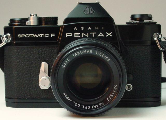 A vintage black Pentax Spotmatic F camera with an SMC Takumar 1:1.4/50 lens is shown from the front, displaying details such as controls and branding.