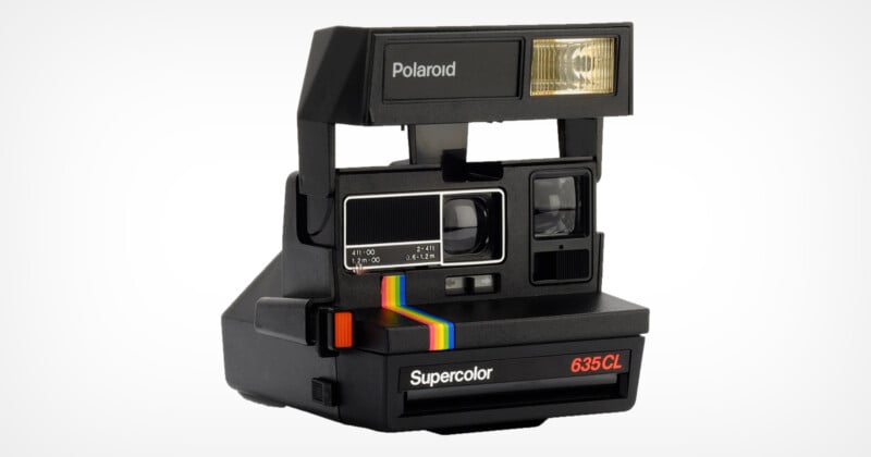 A vintage Polaroid Supercolor 635CL instant camera with a rainbow stripe design. It features a built-in flash and a classic black exterior.