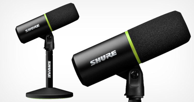 A black Shure microphone with green accents is mounted on a stand. Another view of the same microphone is displayed in the background, angled upward. The microphones have a sleek, modern design.