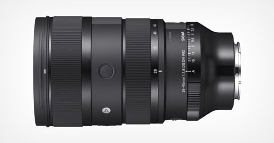 A Sigma camera lens is positioned horizontally against a white background. The lens features a focal length range of 28-45mm and an aperture of f/3.8. Various adjustment rings and control marks are visible, including a focus ring and a zoom ring.