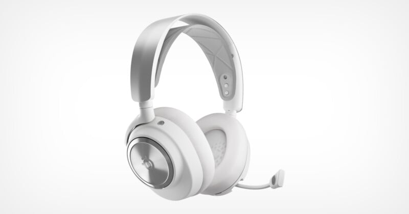 A sleek pair of white over-ear headphones with a built-in microphone. The design features a padded headband and circular ear cups with a metallic accent, creating a modern and minimalist look. The microphone is connected to the left ear cup.