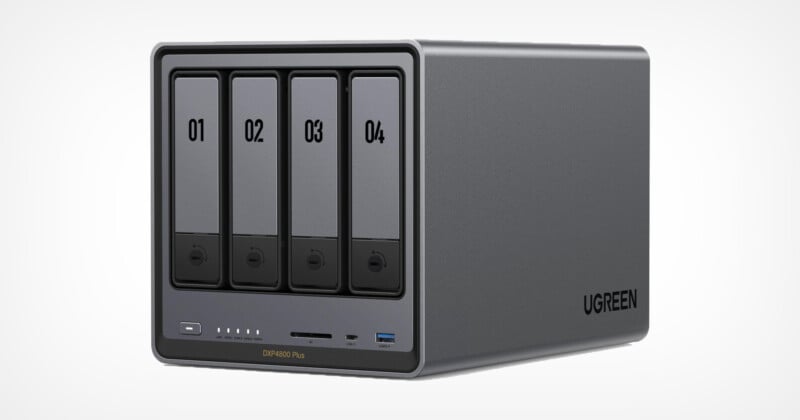 A UGREEN external storage device with four drive bays, each numbered from 01 to 04. The front panel includes indicator lights, a power button, and USB and SD card slots. The device is sleek and gray with the UGREEN logo on the side.